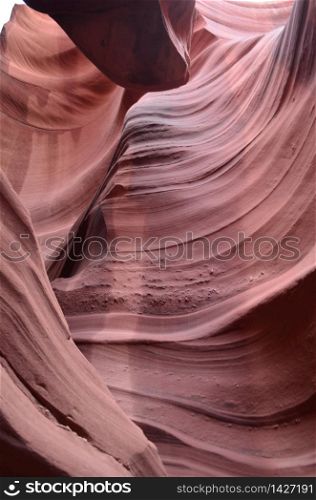 Red sandstone carved out from flash floods in a slot canyon.