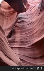 Red sandstone carved out from flash floods in a slot canyon.