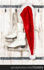 Red Santas hat and white ice skates. Vintage style christmas decoration