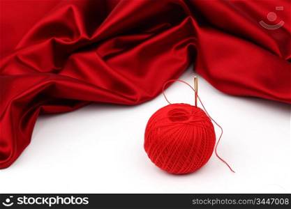 red satin and thread isolated on white