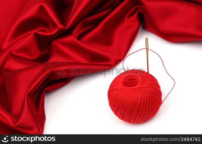 red satin and thread isolated on white