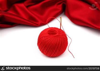 red satin and thread isolated on white