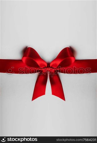 Red satin ribbon bow on white background. Red bow on white