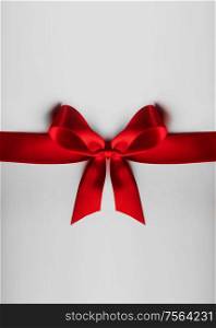 Red satin ribbon bow on white background. Red bow on white