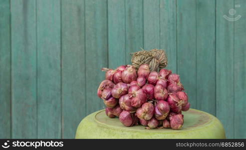 red shallot on plastic basin . red shallot on plastic basin over old wood background