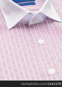 red shirt with a focus on the collar and button, close-up. cotton shirt, close-up