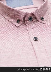 red shirt with a focus on the collar and button, close-up. cotton shirt, close-up