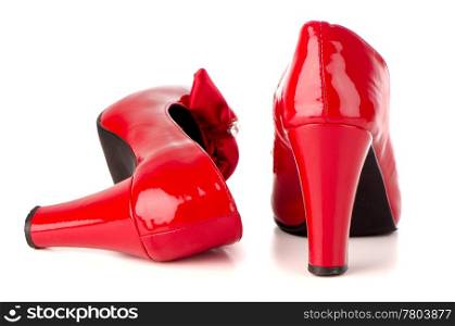 Red shoes isolated on white reflective background.