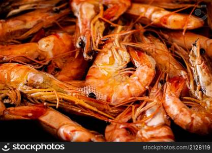 Red shrimp are boiled in water. Macro background. Shrimp texture. High quality photo. Red shrimp are boiled in water. Macro background.
