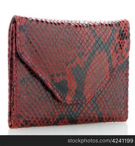 Red snake skin purse isolated on white background.