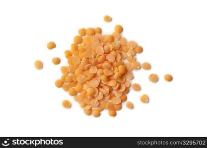 Red split lentils scattered on white background