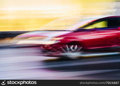 Red Sports Car in a Blurred City Scene