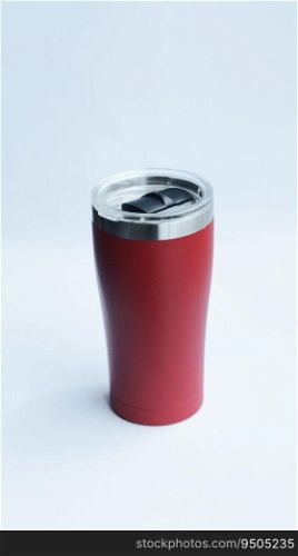 Red stainless steel tumbler and mug vacuum insulated double wall travel cup with lid isolated on white.