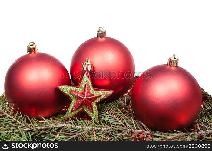 red star and red Christmas baubles on green firtree branch isolated on white background