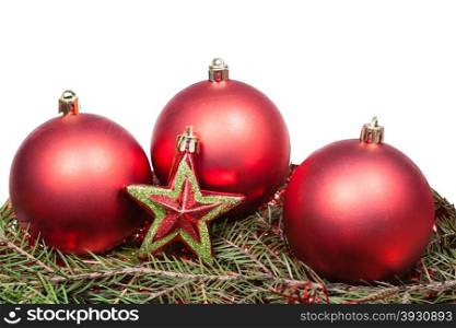 red star and red Christmas baubles on green firtree branch isolated on white background