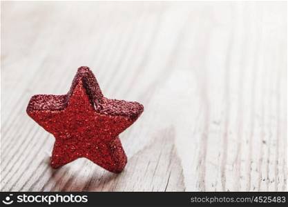 Red star on wooden background. Small Red star on wooden background close-up