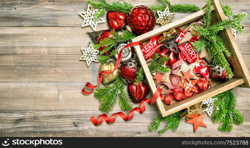 Red stars, baubles, ribbons. Christmas decorations, toys and ornaments with christmas tree branches. Top view