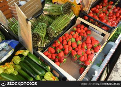 red strawberries and vegetables on counter