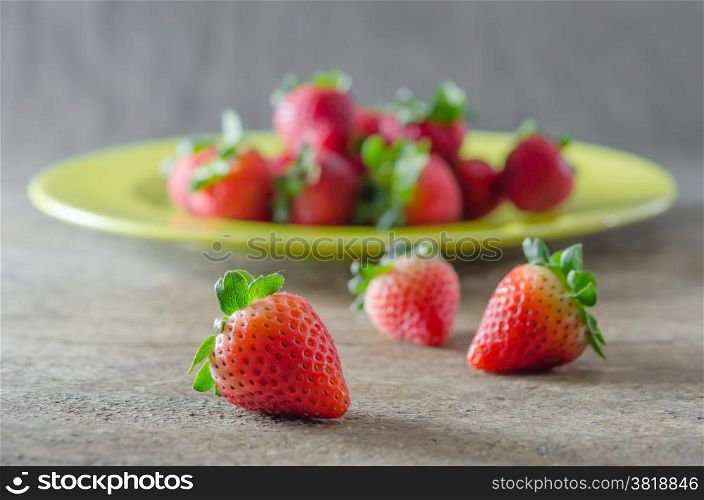 red strawberries. still life of fresh red strawberries on dish over wooden background