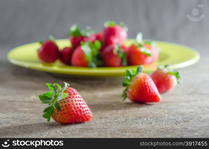 red strawberries. still life of fresh red strawberries on dish over wooden background