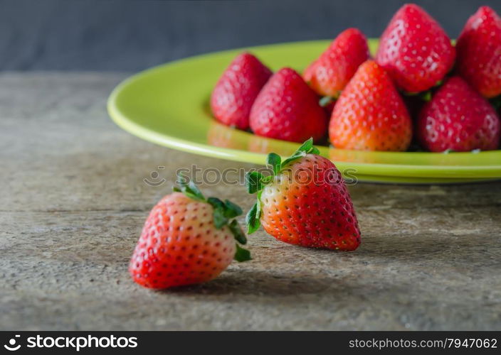 red strawberries. still life of fresh red strawberries on dish over wooden background