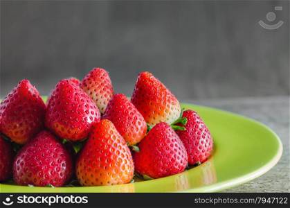 red strawberries. still life of fresh red strawberries on dish over wooden background