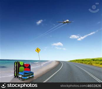 Red suitcase and plane in the blue sky above