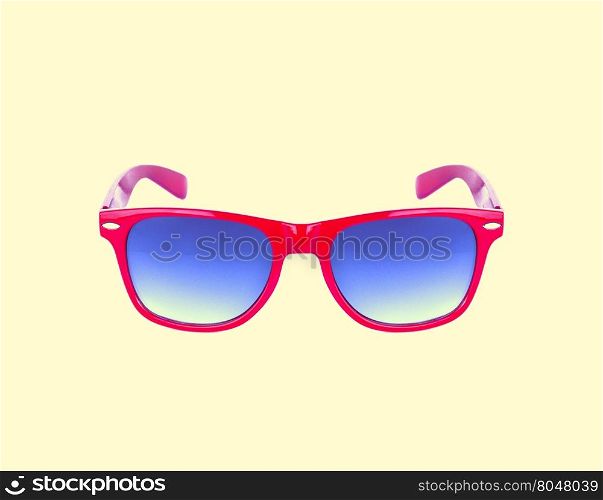Red sun glasses isolated over the yellow background
