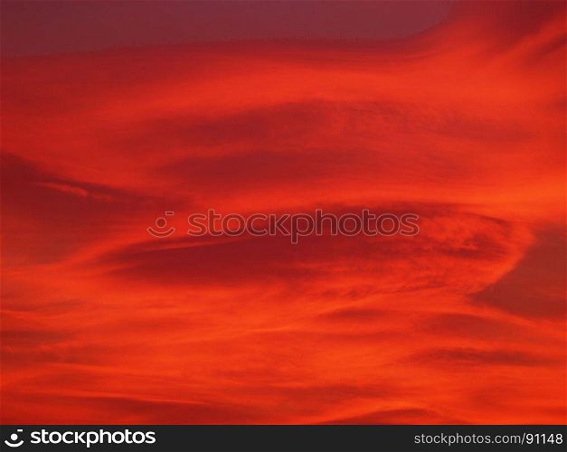 red sunset sky with clouds background. dramatic red sky with clouds at sunset useful as a background