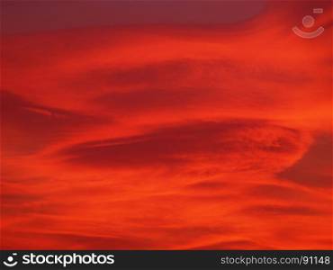 red sunset sky with clouds background. dramatic red sky with clouds at sunset useful as a background
