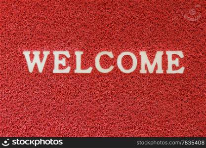 Red synthetic doormat with welcome word