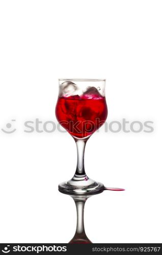 Red syrup and ice in a glass on the white background.