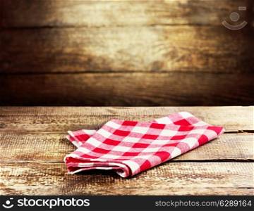 red tablecloth over rustic wooden background