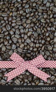 Red tartan ribbon on coffee beans background&#xA;