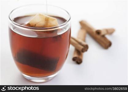 Red tea cup with cinnamon