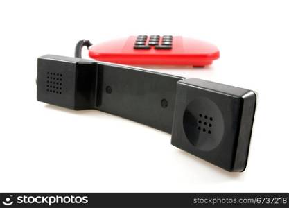 red telephone with black receiver over a white background