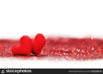 Red textile hearts on glitters isolated on white, Valentines day concept