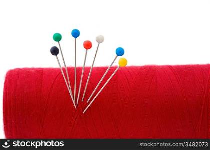 red thread ball of yarn a over white background