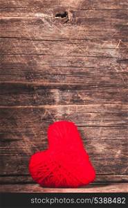 Red thread heart over old shabby background. Valentine concept