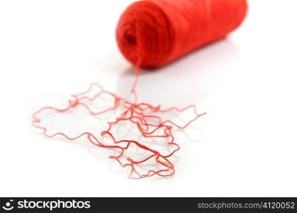 Red thread spool isolated over white