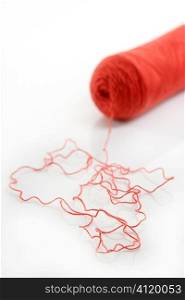 Red thread spool isolated over white