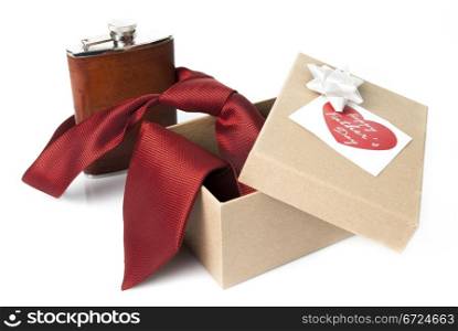 Red tie, leather flask, gift box and heart shaped card for fathers day