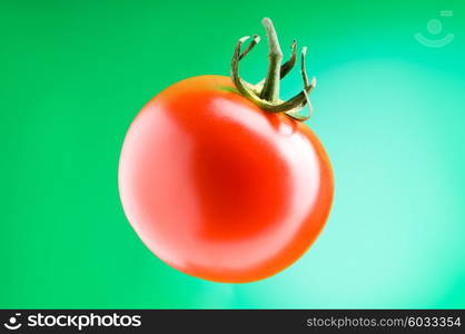 Red tomato against gradient background