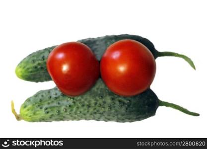 Red tomato and two cocumbers isolated on the white background