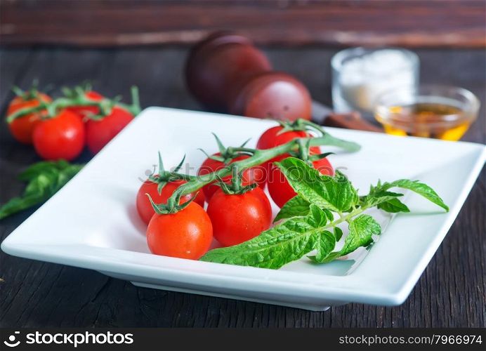red tomato cherry, fresh tomato on a table