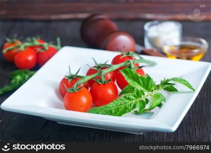 red tomato cherry, fresh tomato on a table