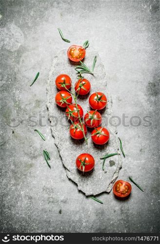 Red tomatoes on a stone stand. On a stone background. . Red tomatoes on a stone stand.