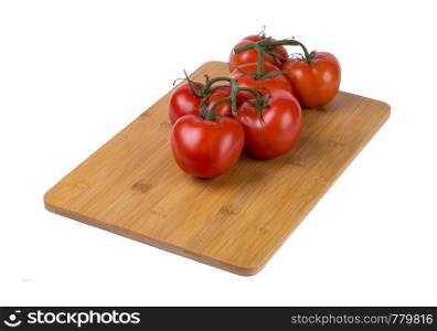 red tomatoes on a twig, lie on a wooden board, image on a white background