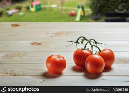 Red tomatoes on a wooden table