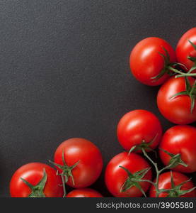 red tomatoes on black. top view